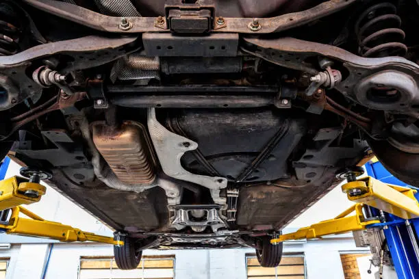 Underside of a car showing underbody components for inspection and auto repair